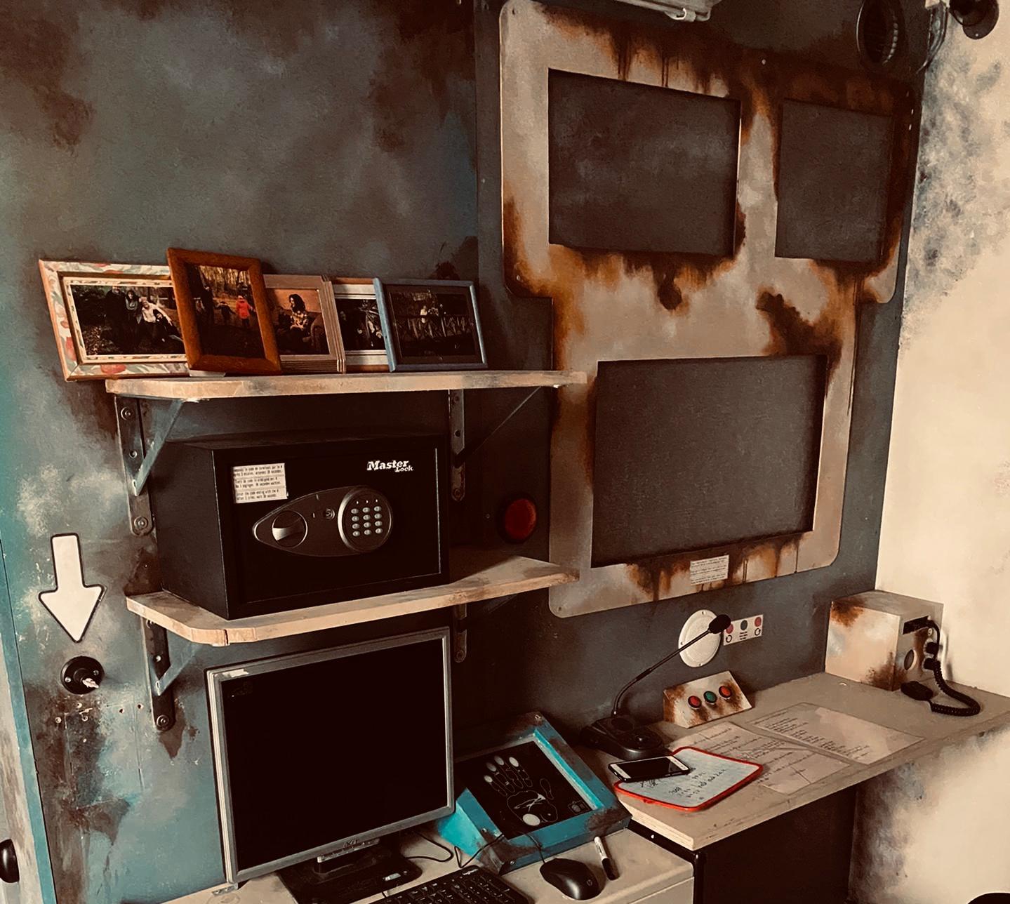 interior of escape game Panic Room with computer, old screens, vault